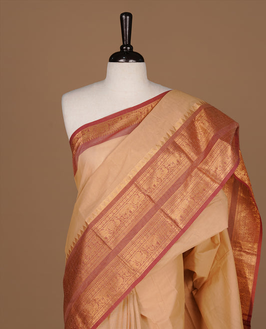 Sandalwood Colour chettinad cotton saree featuring Elegant plain body, complemented by contrast Brick red colour with gold zari border, paired with matching blouse.