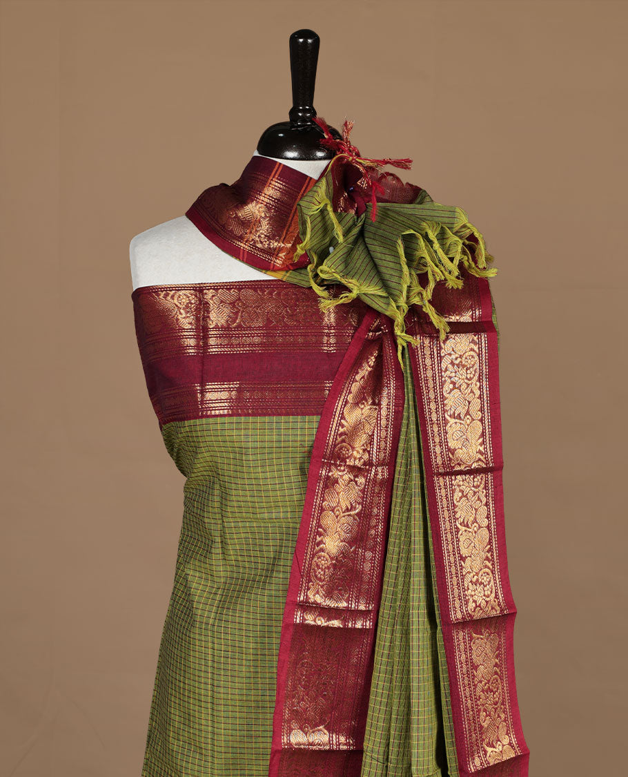Mehandi colour chettinad salwar set featuring check pattern on body,contrast red colour with gold zari border, paired with matching bottom and dupatta.