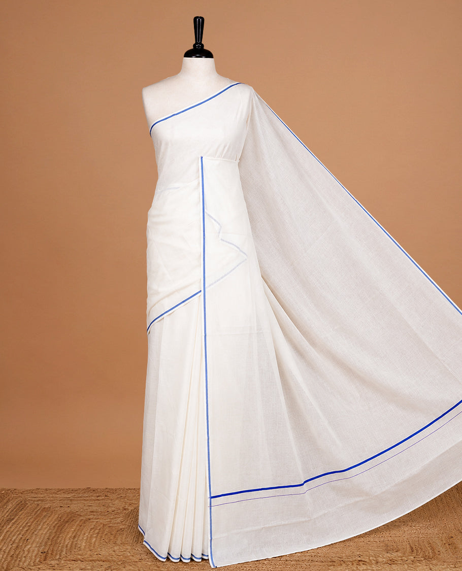 Cream Colour cotton Kerala Saree Featuring A Plain Body, Enhanced By A Minimalistic Blue Border, Paired With A Matching Blouse Piece.