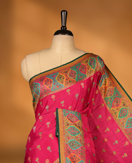 Rani Pink colour Pashmina silk saree densely woven with intricate multicolour floral motifs across the body, framed by an opulent arabesque border and grand storytelling pallu, paired with a matching woven border blouse piece