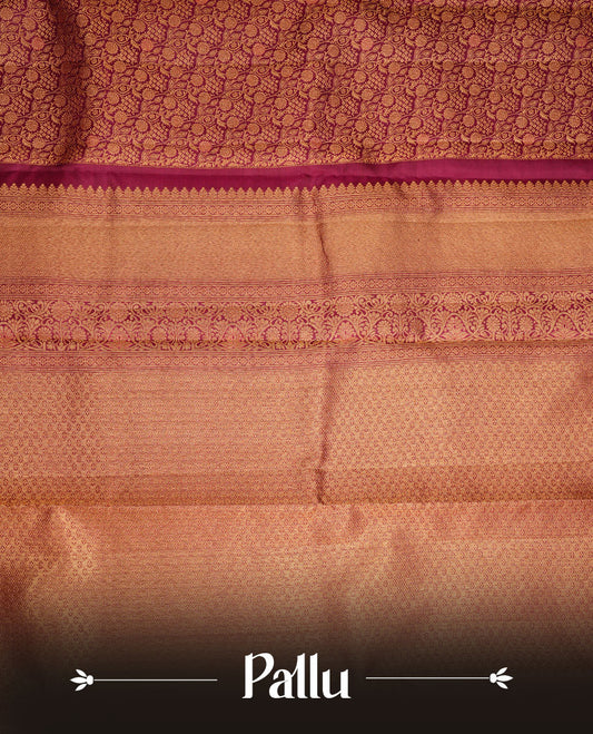 Burgundy colour kancheepuram silk saree featuring gold zari pattern across body, complemented by selfcolour border traditional zari border, paired with matching blouse piece.