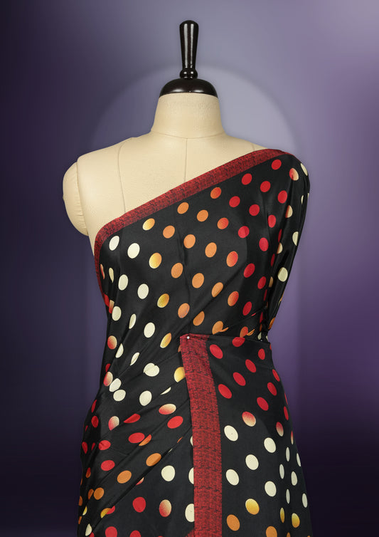 Black colour saree with with large big polka dots on the body, self stripped pallu & Comes with a stylish matching blouse.