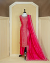 Rani Pink colour churidar set featuring an all-over woven floral pattern and an intricately embellished neckline, paired with matching dupatta & solid pants