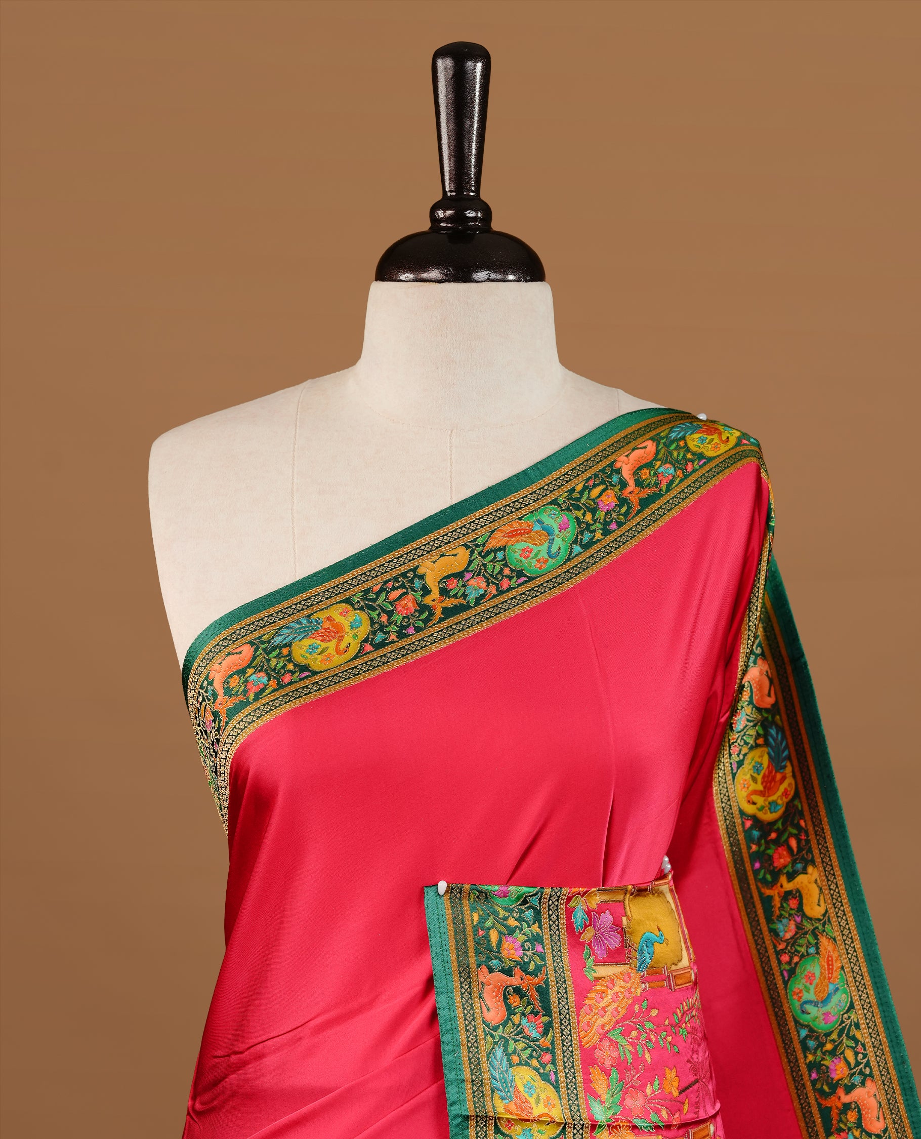 Pink colour Pashmina Saree featuring a plain lustrous body, a multicolour traditional woven border, a rich traditional woven pallu with architectural and floral motifs, paired with a matching pink blouse.
