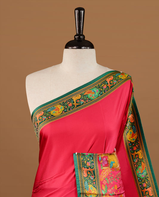 Pink colour Pashmina Saree featuring a plain lustrous body, a multicolour traditional woven border, a rich traditional woven pallu with architectural and floral motifs, paired with a matching pink blouse.