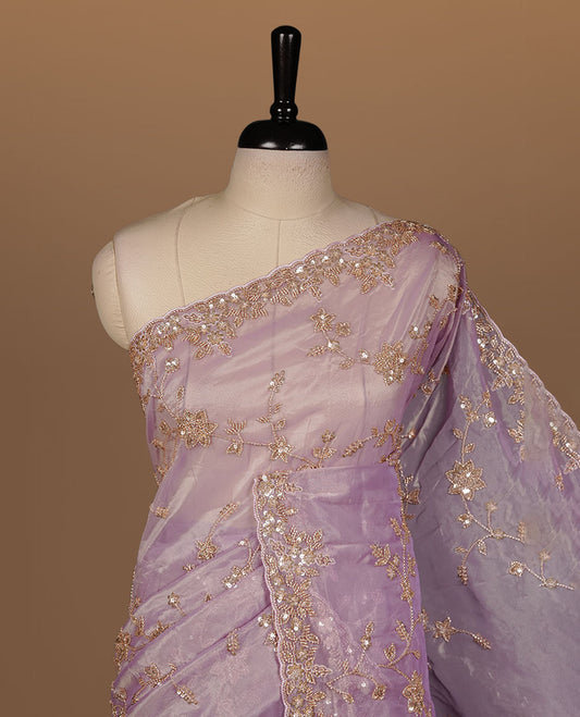 Pastel purple colour net organza saree featuring cut beats and sequins floral kodi pattern on body, enhanced with worked border and cut beats work on blouse piece.