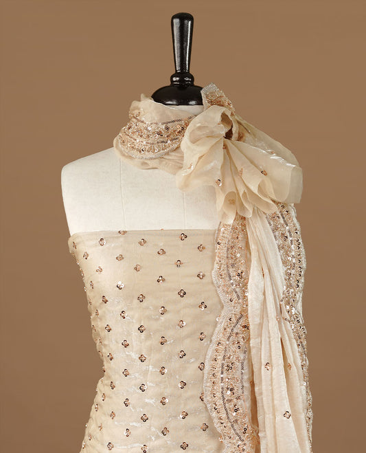 Cream colour churidhar material featuring cut beads and sequins work on the body, paired with a matching unstitched bottom and worked dupatta.