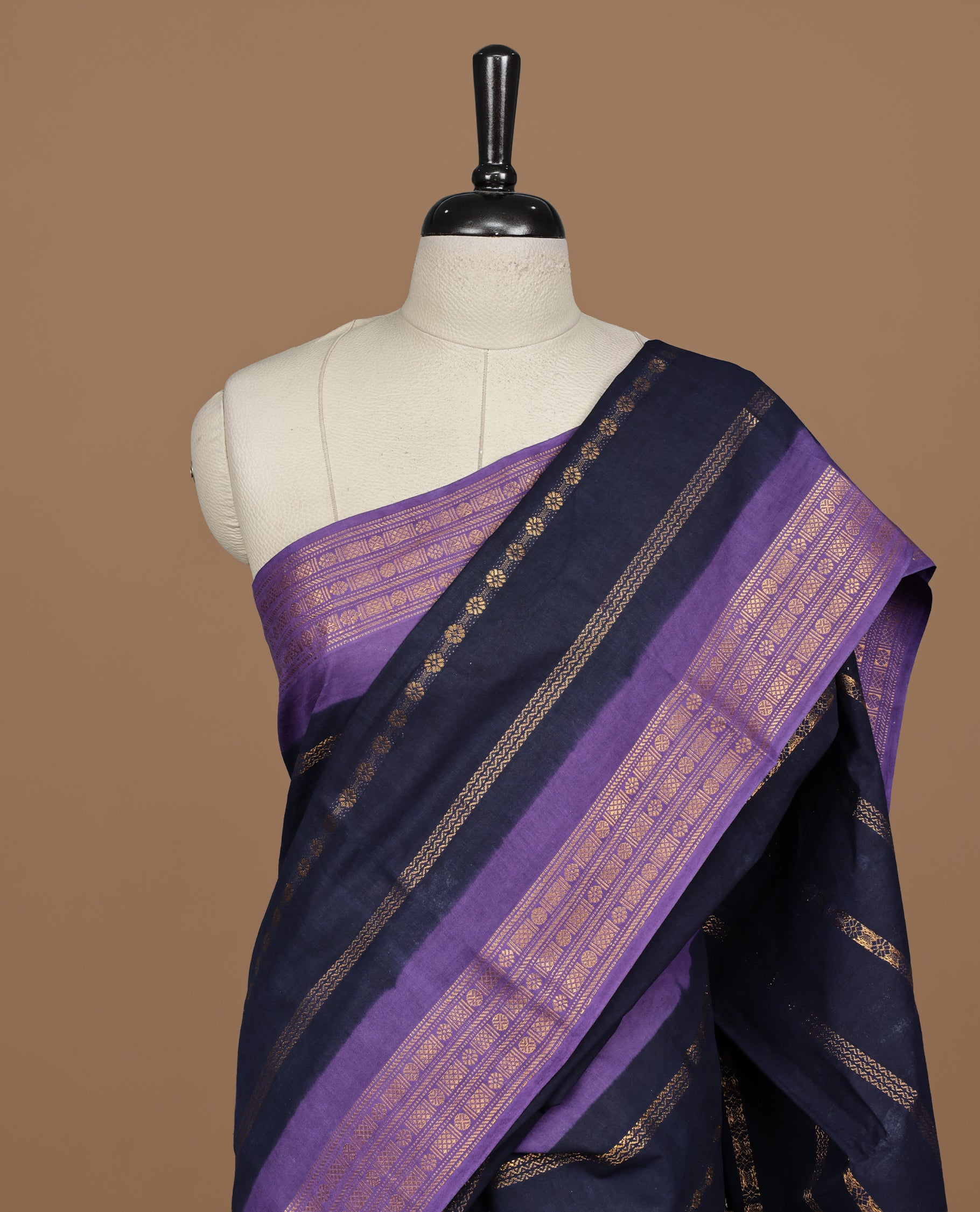 Navy Blue colour Sungudi cotton saree featuring Gold zari Stripes on body, Gold zari on Contrast Purple colour border, paired with matching blouse piece.