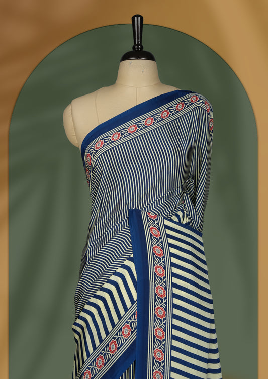 Navy blue and cream colour saree with fine vertical stripes and traditional floral borders & A bold circular motif enhances the pallu, giving it a contemporary twist, Lightweight and graceful, paired with matching blouse.
