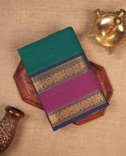 Aqua lake colour chettinad cotton saree featuring elegant plain body highlighting contrast magenta and blue colour with gold zari Peacock border, pallu and paired with matching blouse piece.