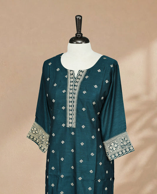 Teal colored Kurti featuring cream colored threadwork on the body, a round neckline adorned with intricate thread detailing, and 3/4 sleeves.