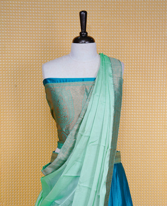 Teal Green colour Half saree featuring Plain skirt with Zari border on contrast Light green colour border, Unstitched Blouse and matching dupatta.