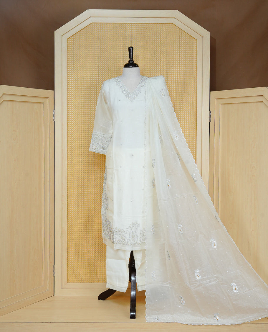 Off White colour churidar set featuring delicate Stone Work on the V-neckline, sleeves and hem, paired with matching solid pants and an embellished sheer dupatta.
