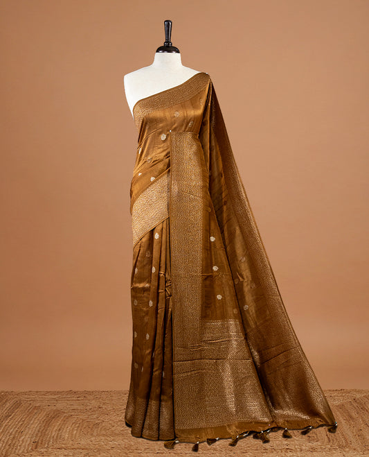 Burnt Mustard colour Semi banaras tussar georgette Saree featuring Antique zari motifs on body, enhanced with antique zari border, paired with a matching blouse piece.