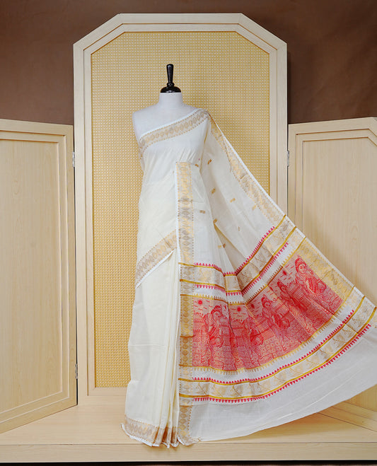 Cream Colour Cotton Kerala Saree Featuring Gold Buttas on the Body, a Classy Gold Zari Border, and a Traditional Red Colour Lord Krishna Thread work and Gold Zari Pallu, Paired with a Matching Blouse Piece.