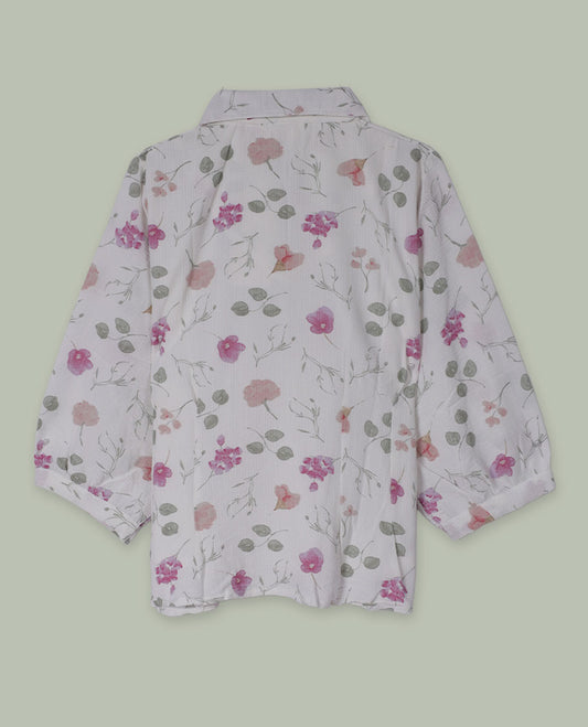 White floral printed shirt top with collared neckline, three-quarter sleeves, and front button placket framed by embroidered lace detailing.