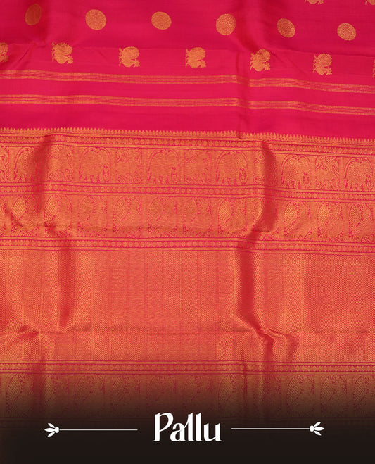 Rani pink colour pure traditional Kancheepuram silk saree adorned with gold zari peacock & chakra motifs across the body, featuring elegant traditional borders, beautifully paired with a matching blouse piece.