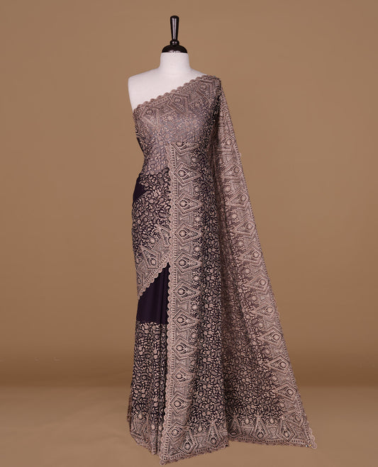 Deep purple colour georgette designer saree featuring Gold thread floral pattern on body highlighting with stone and scalp border, paired with matching blouse piece.