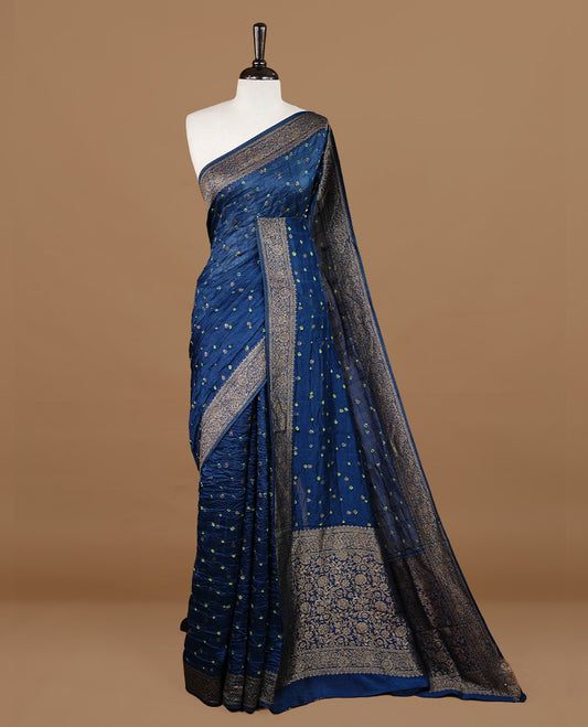 Persain Blue colour Banarasi Bandhani silk saree featuring intricate antique zari circle Buttas across the body, complemented by an elegant antique zari border. Comes paired with a matching blouse piece