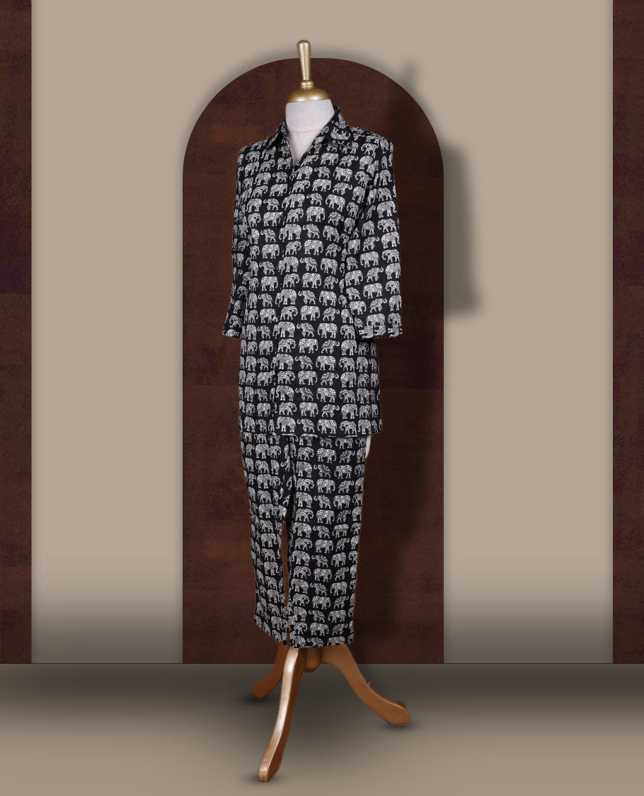 Black colour cotton coord set featuring charming elephant prints all over, Designed with a classic shirt collar and 3/4 sleeves, paired with matching straight pants for a trendy, relaxed, and comfy everyday look.