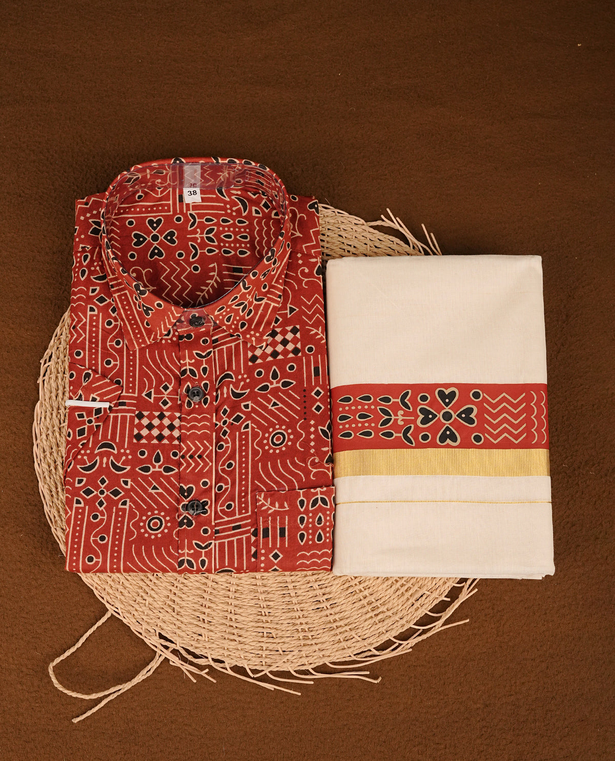 Maroon colour shirt featuring Floral Pattern printed body, paired with cream colour double dhoti featuring Gold kara with printed border.