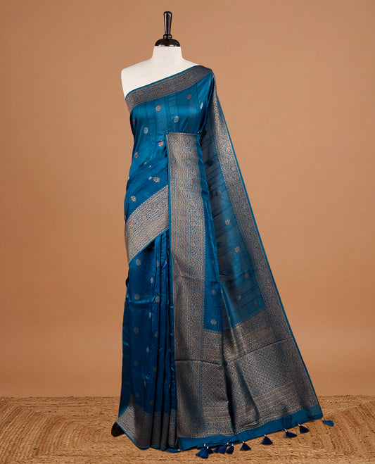 Light aqua colour Semi banaras tussar georgette Saree featuring Antique zari motifs on body, enhanced with antique zari border, paired with a matching blouse piece.
