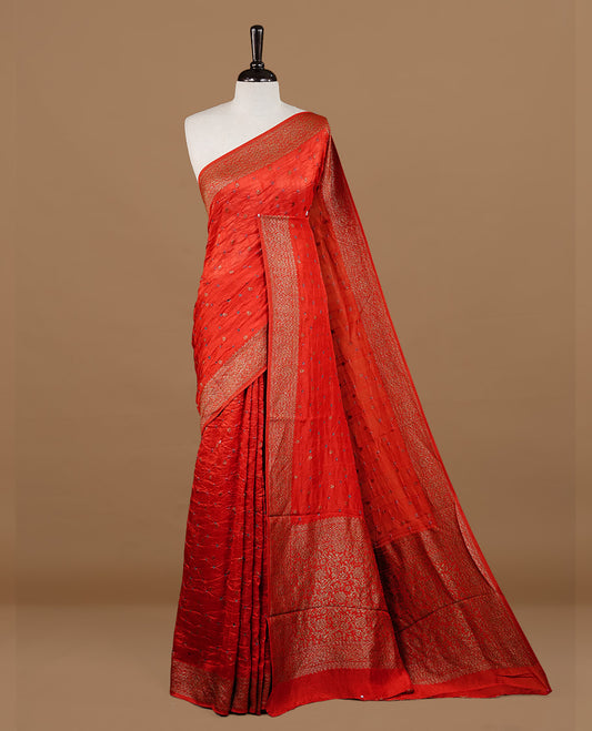 Red colour Banarasi Bandhani silk saree featuring intricate antique zari circle Buttas across the body, complemented by an elegant antique zari border. Comes paired with a matching blouse piece