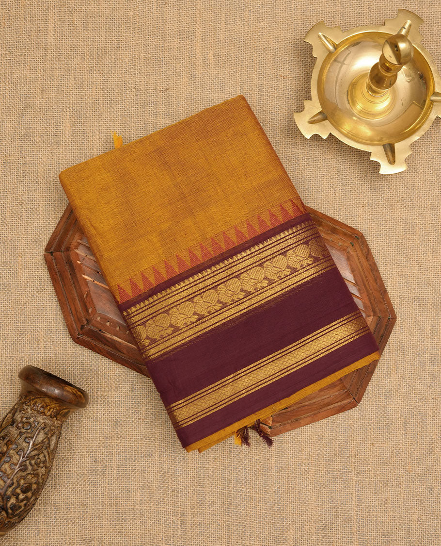 Mustard colour chettinad cotton saree featuring Purple colour motifs on body, contrast maroon colour border with gold zari temple border, pallu and paired with matching blouse