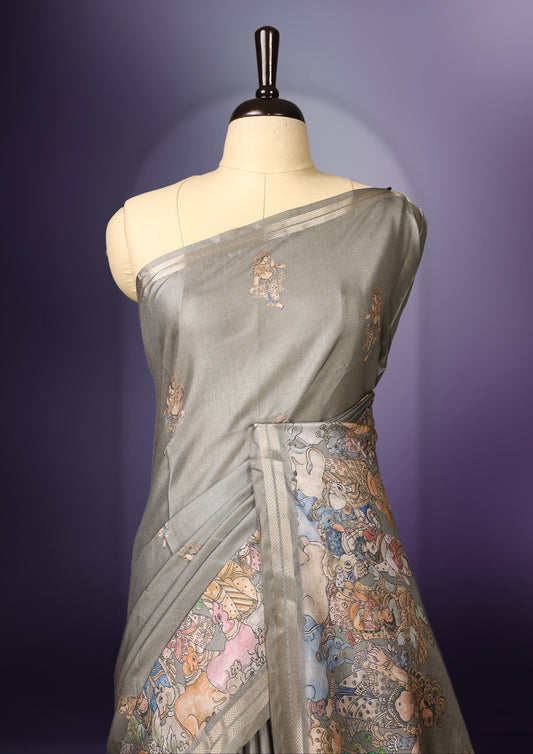 Grey saree adorned with delicate woven motifs across the body, accentuated by an intricately designed multicolour border, and a rich pallu featuring traditional artistic patterns, paired with a matching blouse.