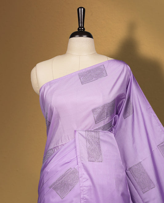Lavender semi soft silk saree featuring woven rectangular motifs on the body, elegant woven border, and rich matching pallu with tassel finish & Comes with a coordinating blouse piece for a graceful look.