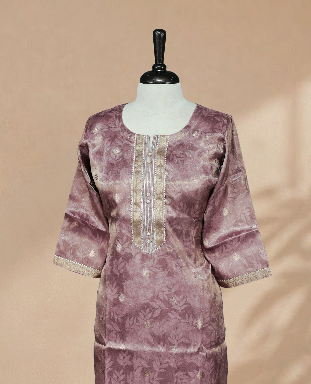Lavender colour Kurti featuring an intricate floral pattern, a  U-shaped neckline adorned with detailed Stone & thread work, and 3/4 sleeves Design
