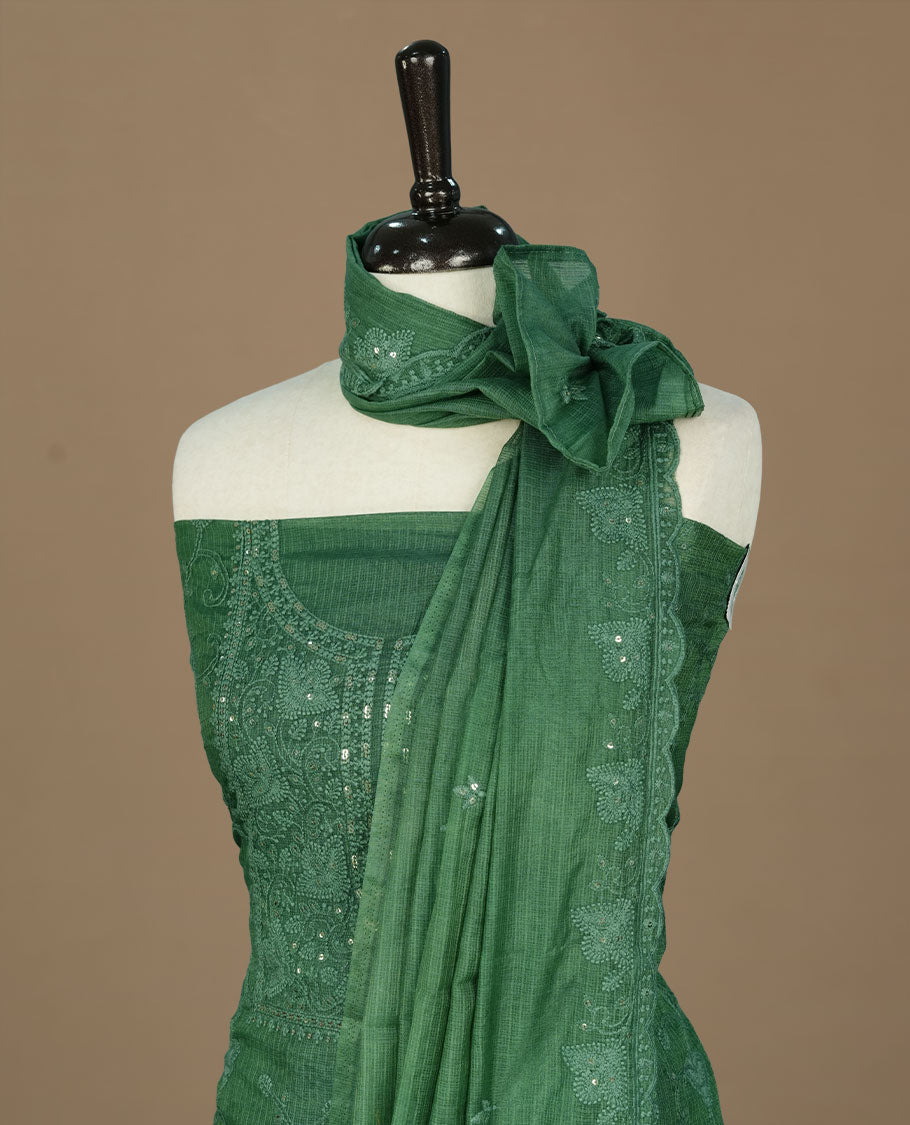 Green colour churidhar material featuring self colour thread and sequins work on body, paired with matching bottom and Dupatta.