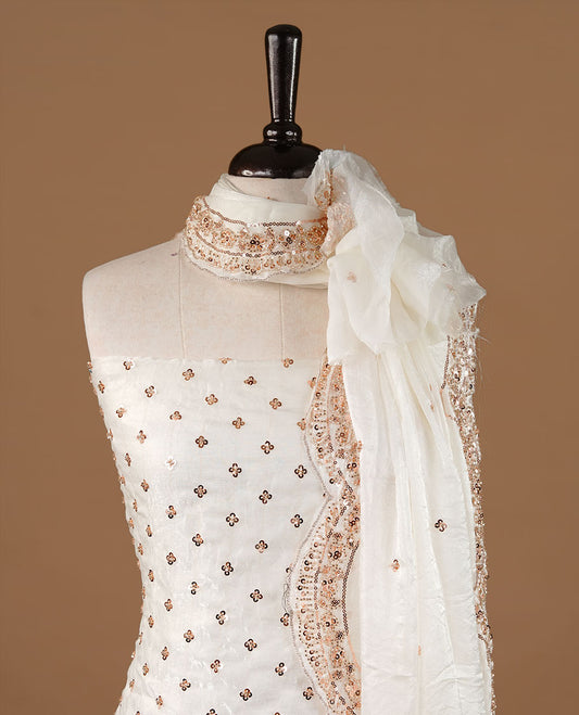 Off white colour churidhar material featuring cut beads and sequins work on the body, paired with a matching unstitched bottom and worked dupatta.