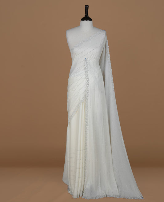 Off white colour designer saree featuring white stone stripes on body, highlighting white stone with scalp border, paired with matching blouse piece.