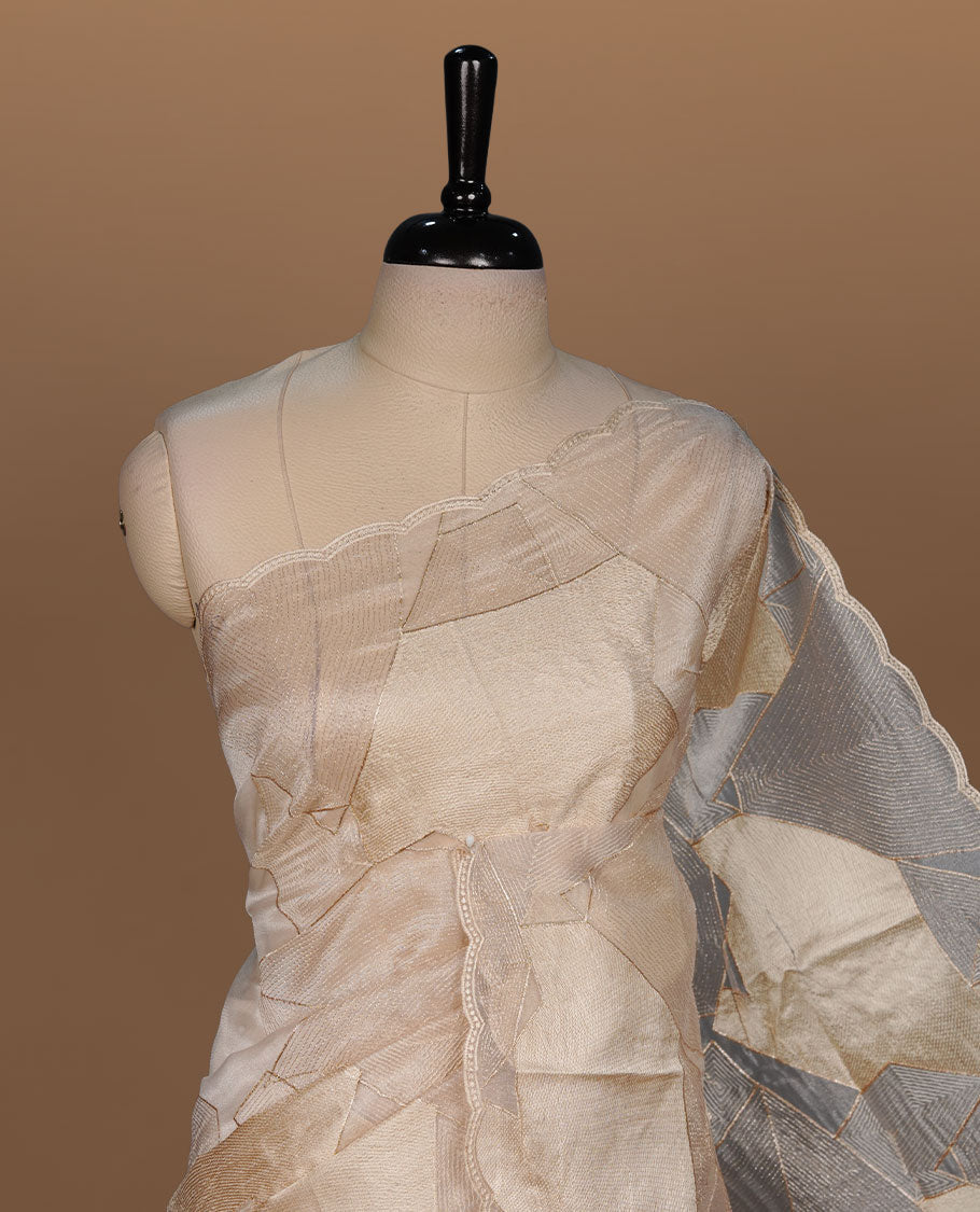 Beige colour Organza designer saree featuring a thread geometric pattern across the body, enhanced with a piping border and cut beats work on matching blouse piece.