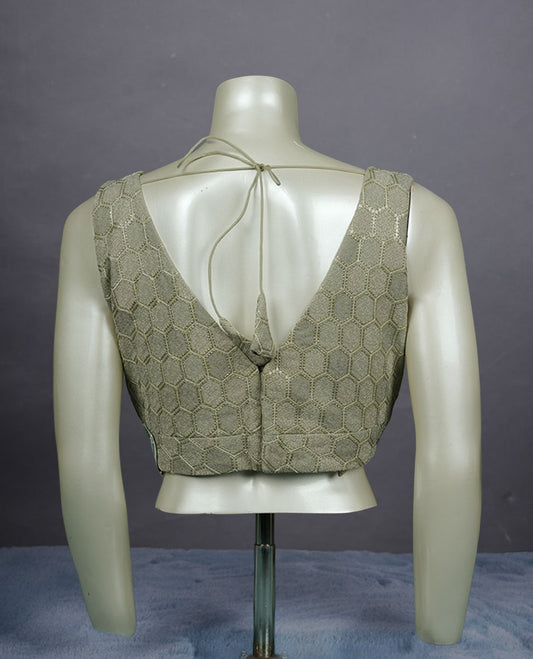 Laurel green colour padded blouse with gold hexagon weave, sleeveless V-neck, and deep V-back with tie-up tassels.