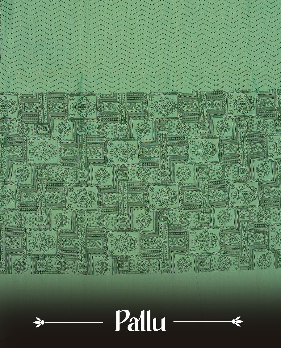 Pista Green colour poly cotton saree with black zigzag line pattern on the body, paired with a matching pallu featuring black chevron lines and panelled floral‑paisley design, and a coordinated all‑over floral paisley patch‑style printed blouse piece.