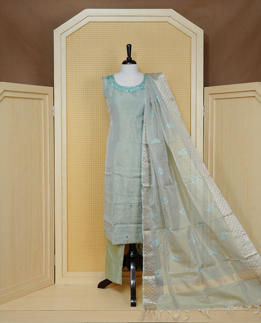Goldish Pastel Green colour Tissue Churidar set featuring delicate floral embroidery on the round neckline, paired with matching solid pants and dupatta