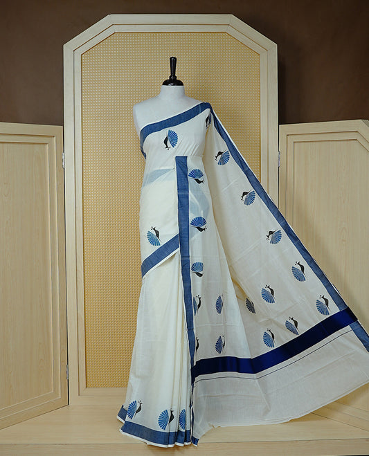 Cream colour Cotton Kerala saree Featuring Classy Plain body for Effortless Elegance, enhancing Navy blue with Peacock Printed border, paired with matching blouse piece.