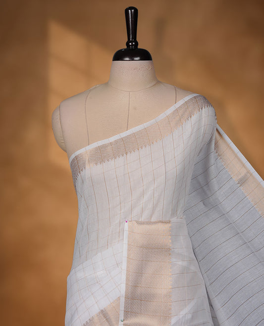 Off-white colour cotton Kerala saree featuring a classic gold kasavu border, detailed with fine woven stripes across the body and pallu, and paired with a matching blouse.