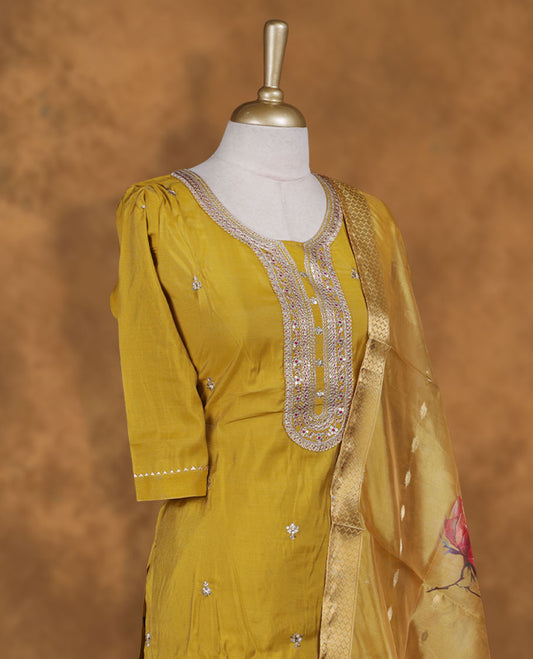 Olive yellow colour churidar set featuring elegant white thread embroidery on the neckline, sleeves, and scattered motifs across the body, Paired with a matching floral printed pattern dupatta