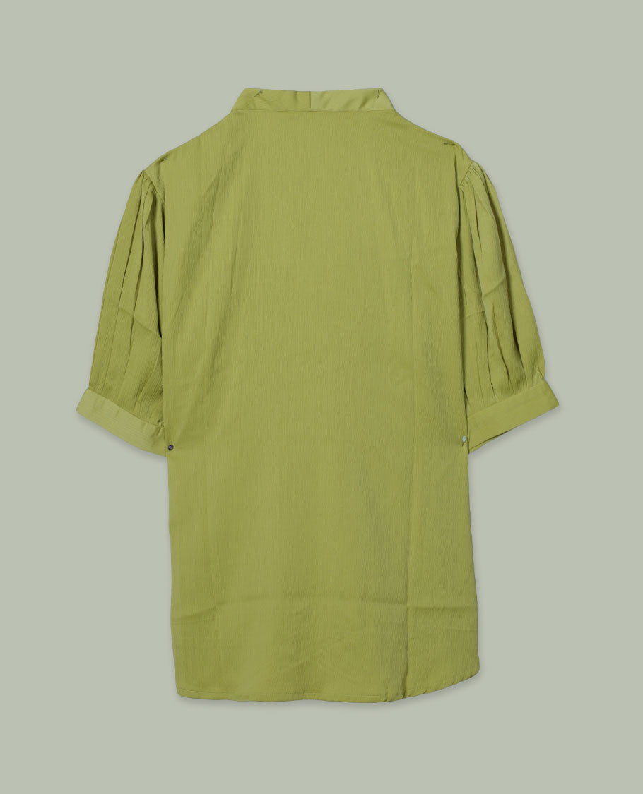 Light green colour V-neck shirt top with single decorative front button, elbow-length cuffed sleeves, and soft gathers at the shoulders.