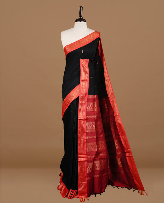 Black colour kalyani cotton saree featuring gold zari motifs on body, highlighting contrast Maroon colour with Antique gold zari border, paired with matching blouse piece.