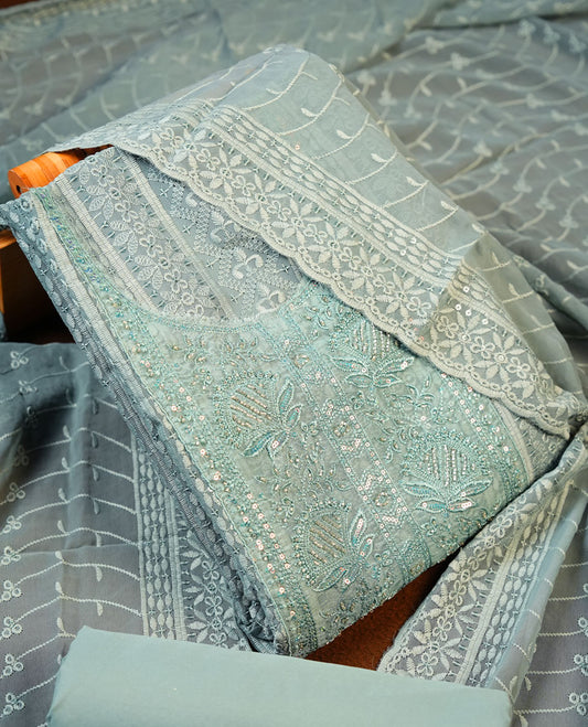 Soft Green colour Churidhar Material featuring Intricate Thread Embroidery with Mirror and Cut Beads Work on the Front Panel, paired with an All Over Embroidered Net Dupatta and Matching Bottom