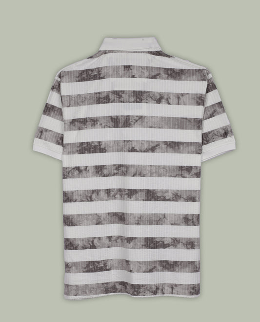 Off white and grey colour striped polo T shirt featuring a collared neck with button placket, half sleeves, and a textured fabric design, enhanced with a front chest patch that adds a trendy casual vibe.