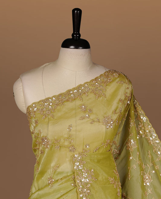 Olive colour net organza saree featuring cut beats and sequins floral kodi pattern on body, enhanced with worked border and cut beats work on blouse piece.