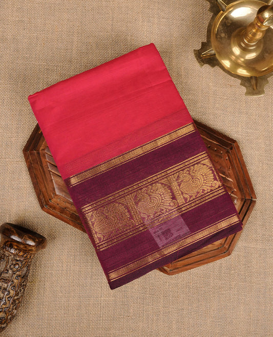 Rani pink colour chettinad cotton saree featuring plain body, contrast burgundy colour with traditional gold zari border paired with matching blouse.