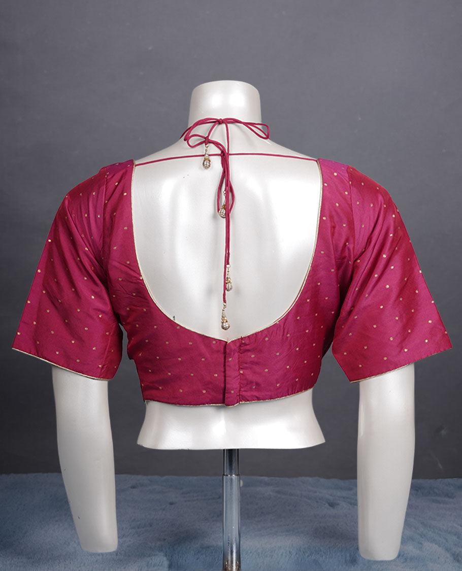 Rani pink colour padded blouse with gold polka dots, V neckline, elbow sleeves, and deep tie-up back.