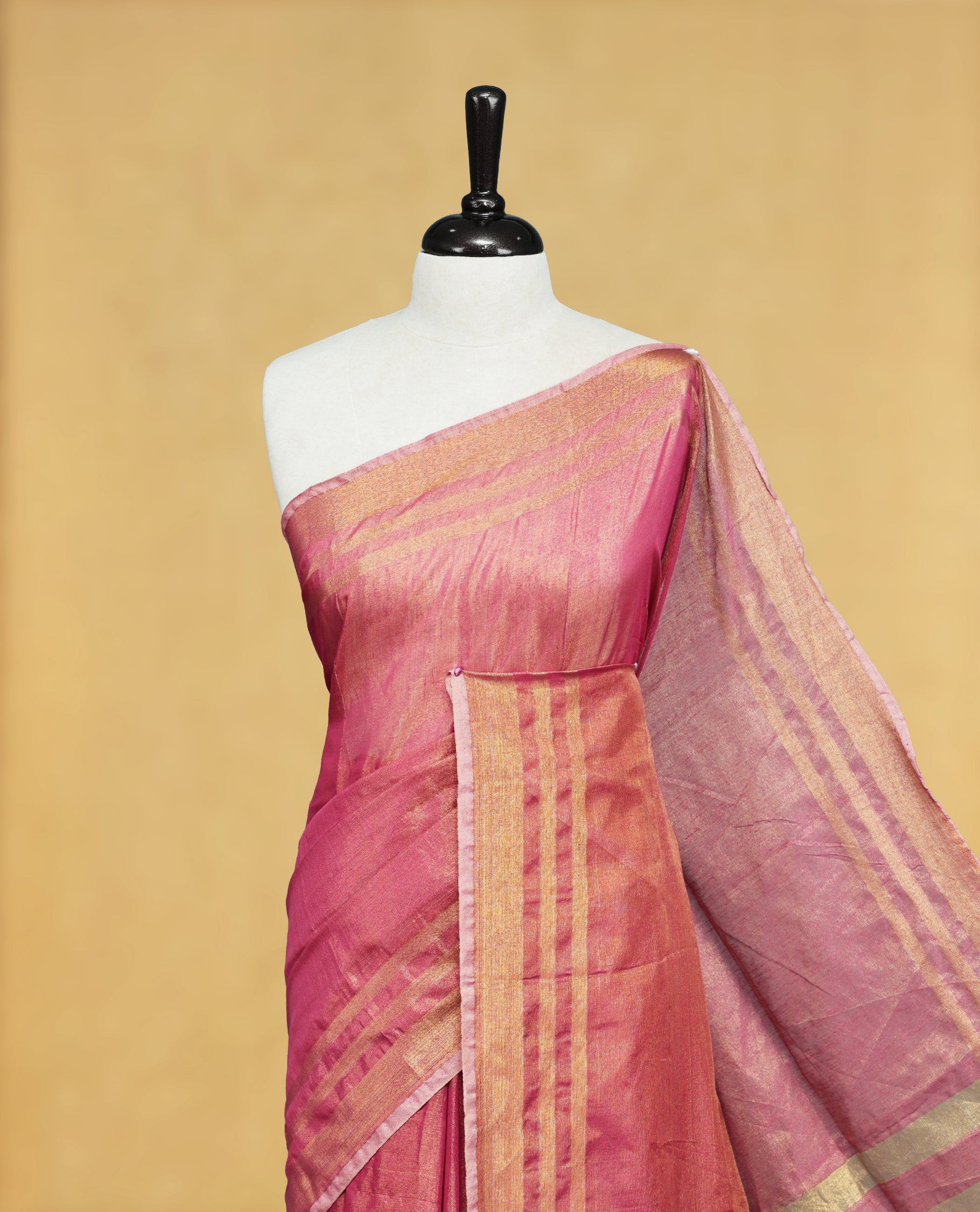 Pink colour Semi Tissue Silk saree featuring Elegant plain body, Enhanced with Gold tissue Border & Striped Pallu & beautiful Tassels for Elegant Prefect Look.