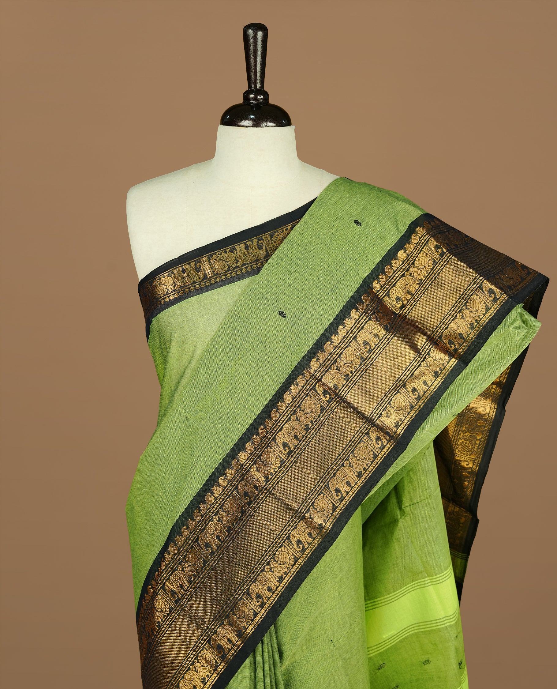 Green colour Chettinad cotton saree featuring motif on body, complemented by Black colour with traditional border, paired with matching blouse Piece.